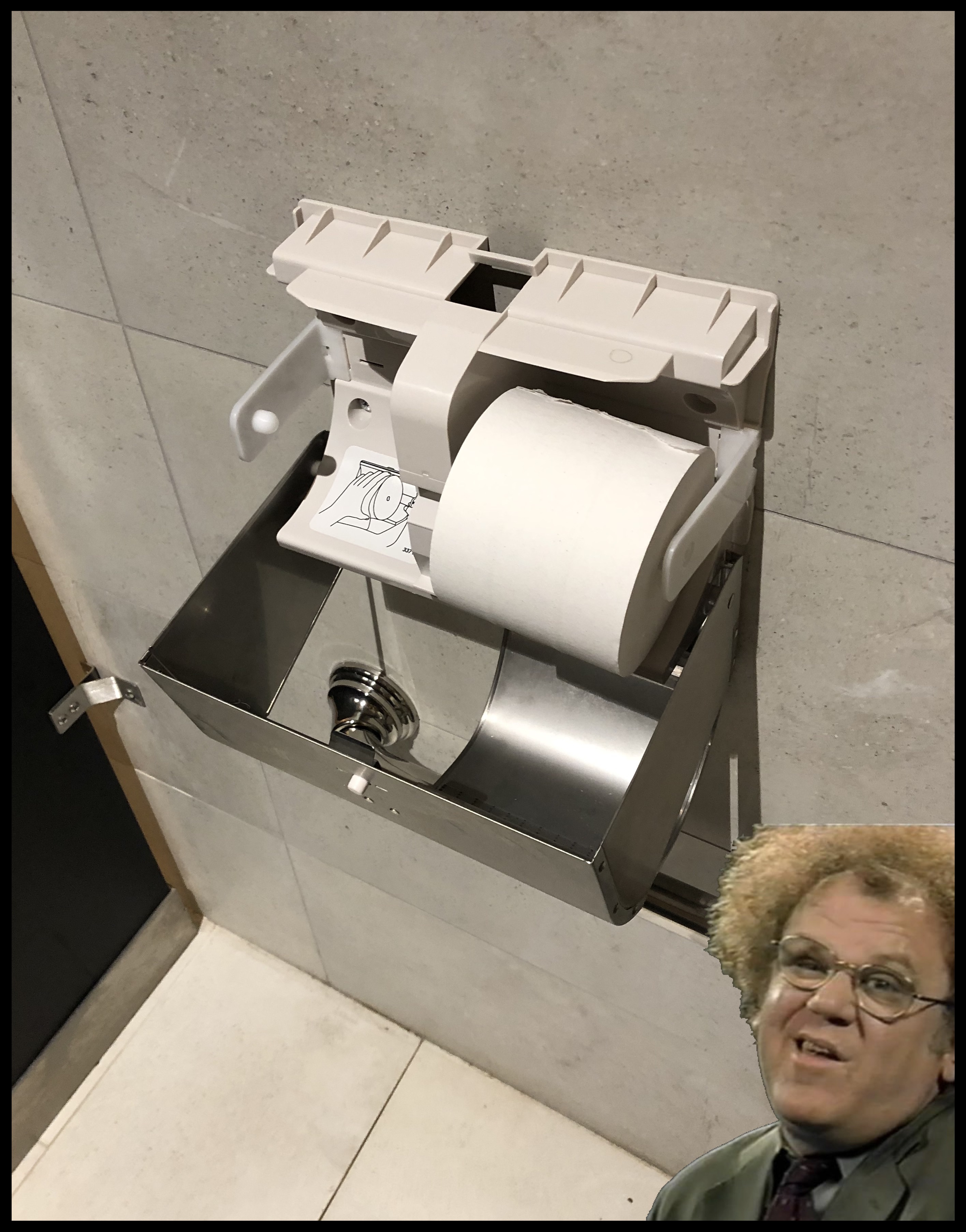 The T.P. dispenser unlocked and hanging open with Steve Brule next to it looking dopey. 